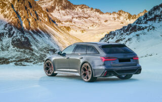 Audi RS6 Avant Performance in luxury rental driving along scenic Italian road